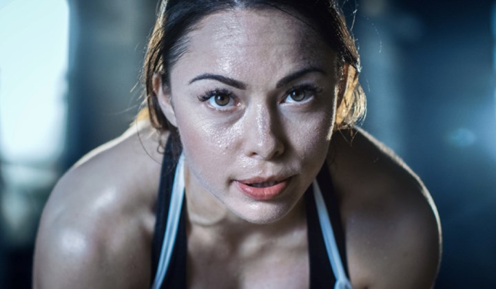 Woman sweating while exercising Woman sweating while exercising